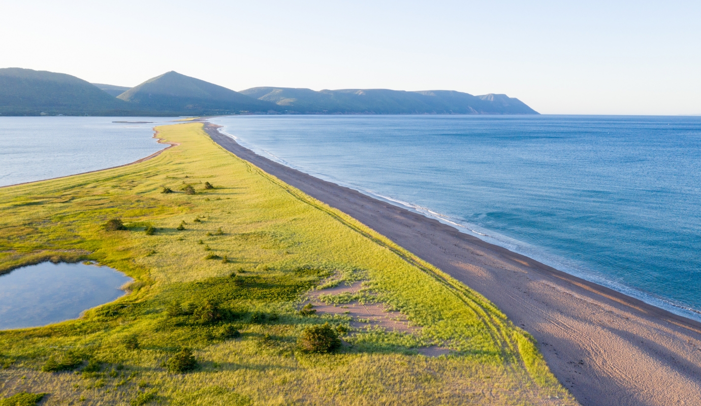 long strip of sandy beach on cape breton island