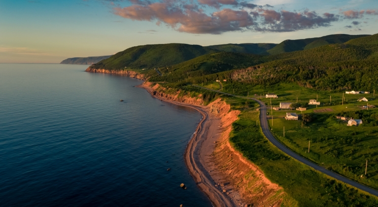 A highway winds past an eroding coastline
