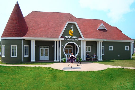 A girl dances outside a building that says Celtic Music Interpretive Centre